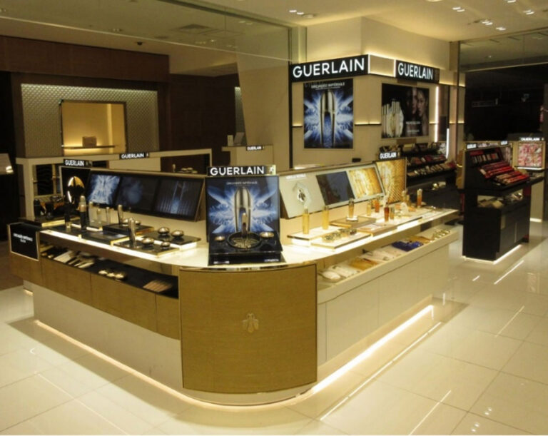 A luxurious Guerlain store showcasing Altavia's expertise in retail design. The store features a modern, minimalist aesthetic with clean lines, elegant displays, and subtle lighting. The overall ambiance is sophisticated and inviting.